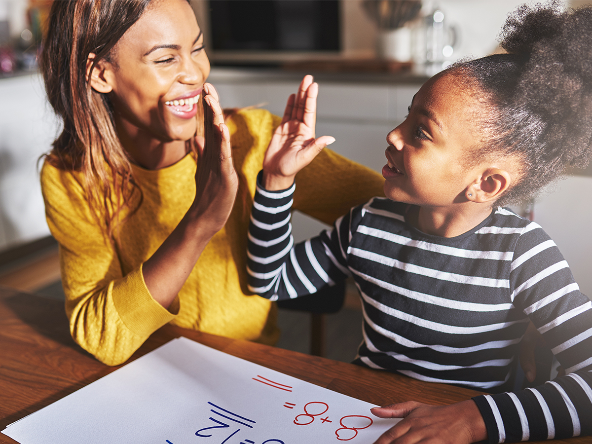 Mother congratulating her child for mastering a concept