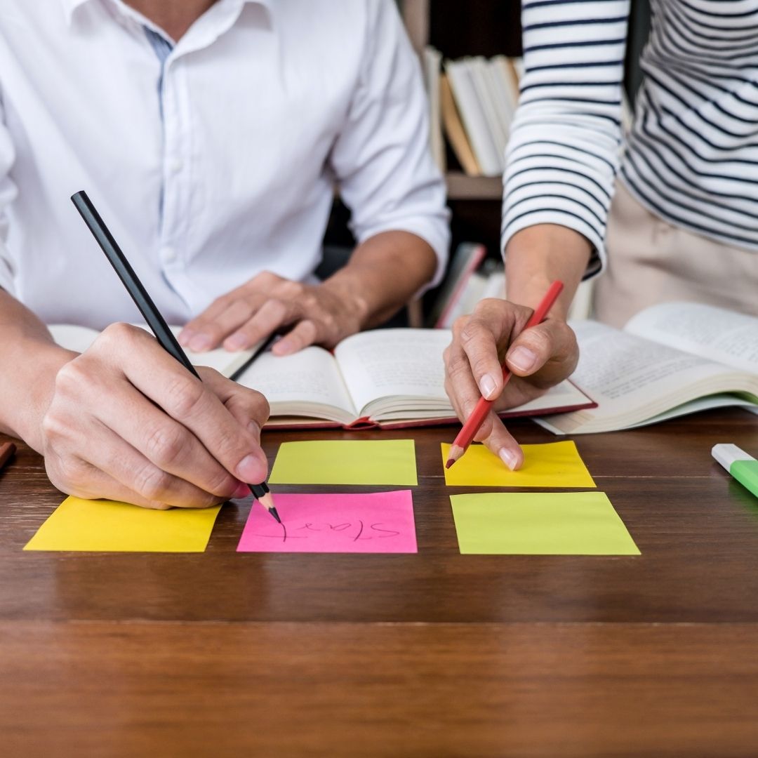people brainstorming on sticky notes people brainstorming on sticky notes