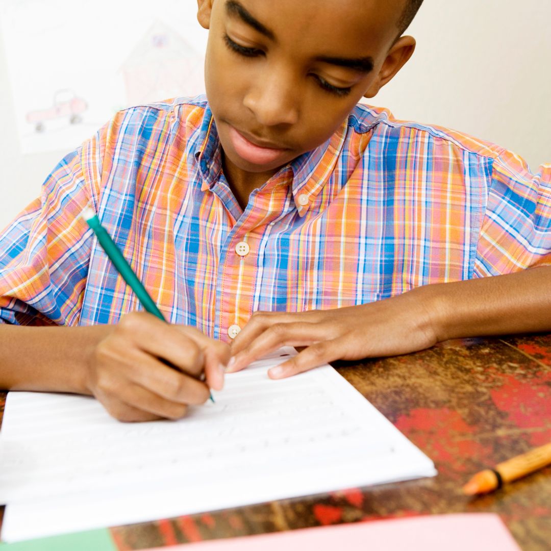 kid writing on paper