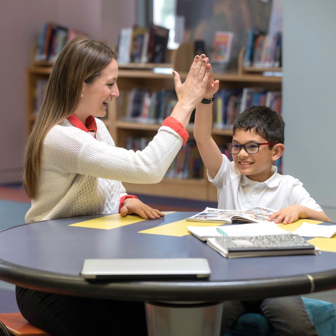 tutor and student high-fiving