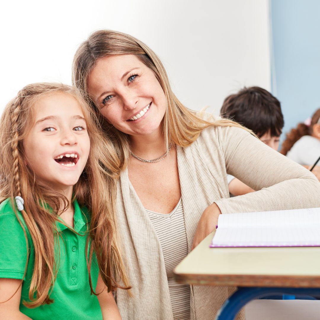 teacher and student in class smiling at camera